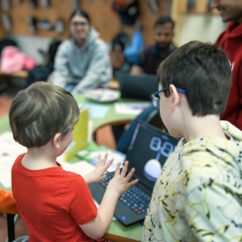 Kids playing with an artificial intelligence computer program.